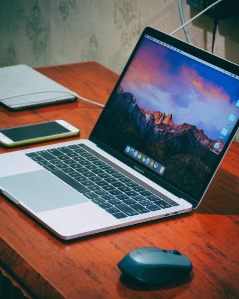 MacBook Pro on brown wooden surface